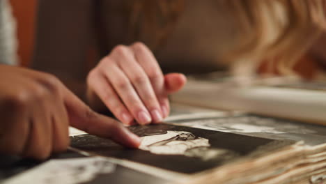 white woman with black husband touch baby picture in album