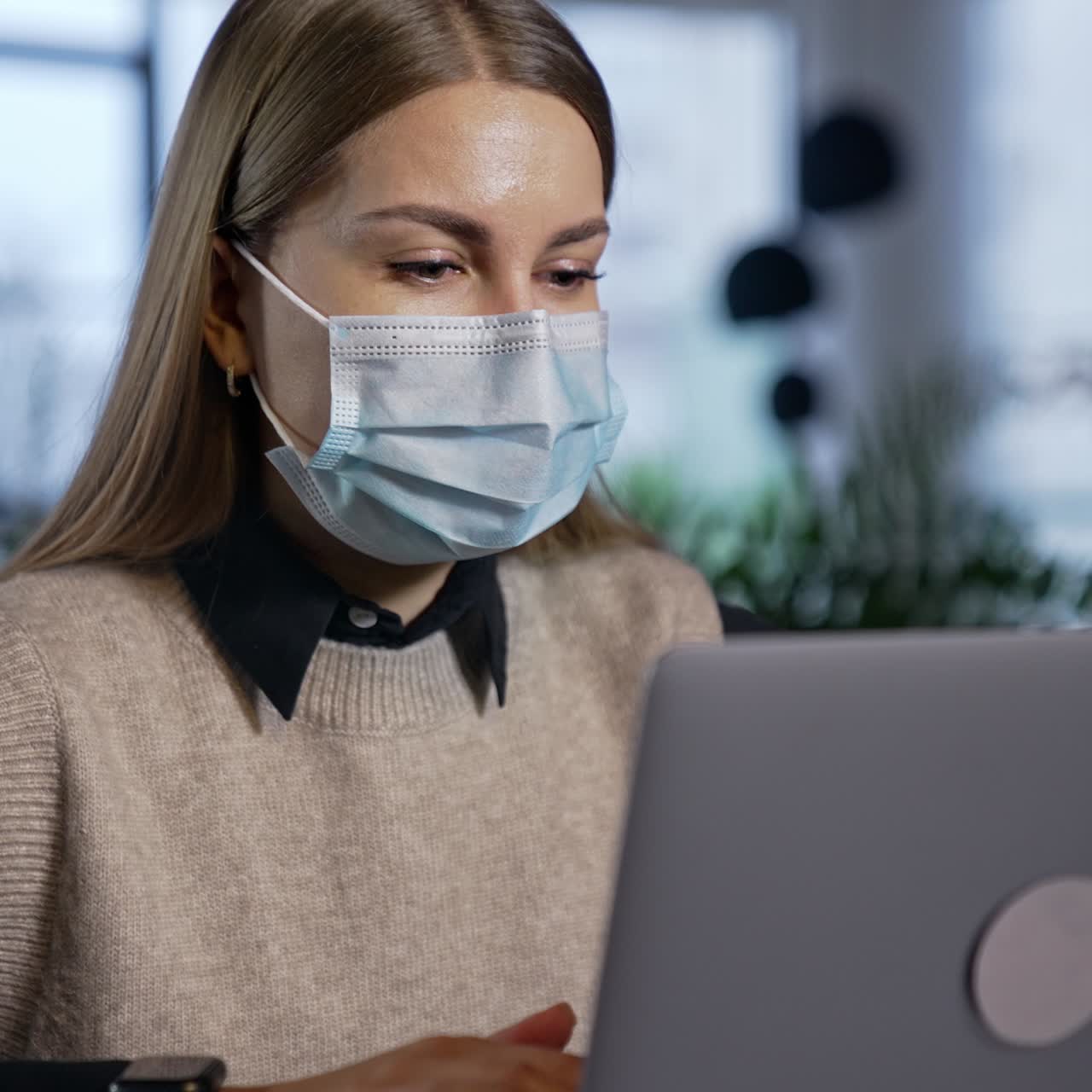 Pretty young lady in mask working with computer. Portrait quarantine employee in mask