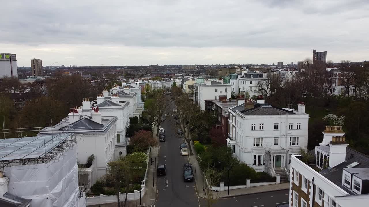 Strada rurale a Londra con case ed edifici creativi di diversi colori sotto un cielo nuvoloso