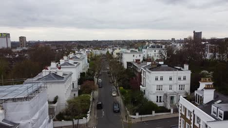 rural road in london with creative houses and buildings in different colors during cloudscape at sky