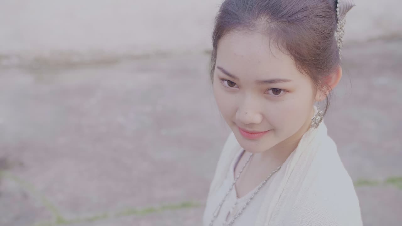 Beautiful Asian Girl In Lao Traditional Costume Smiling And Looking At Camera, Slow Motion