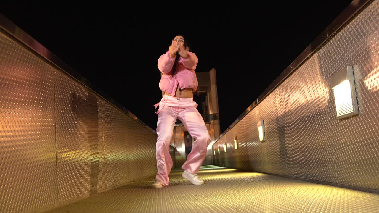 Woman Dancing on a Bridge at Night