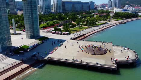 aerial view of weihai xingfu park pier with people standing on monument with ancient writings, china