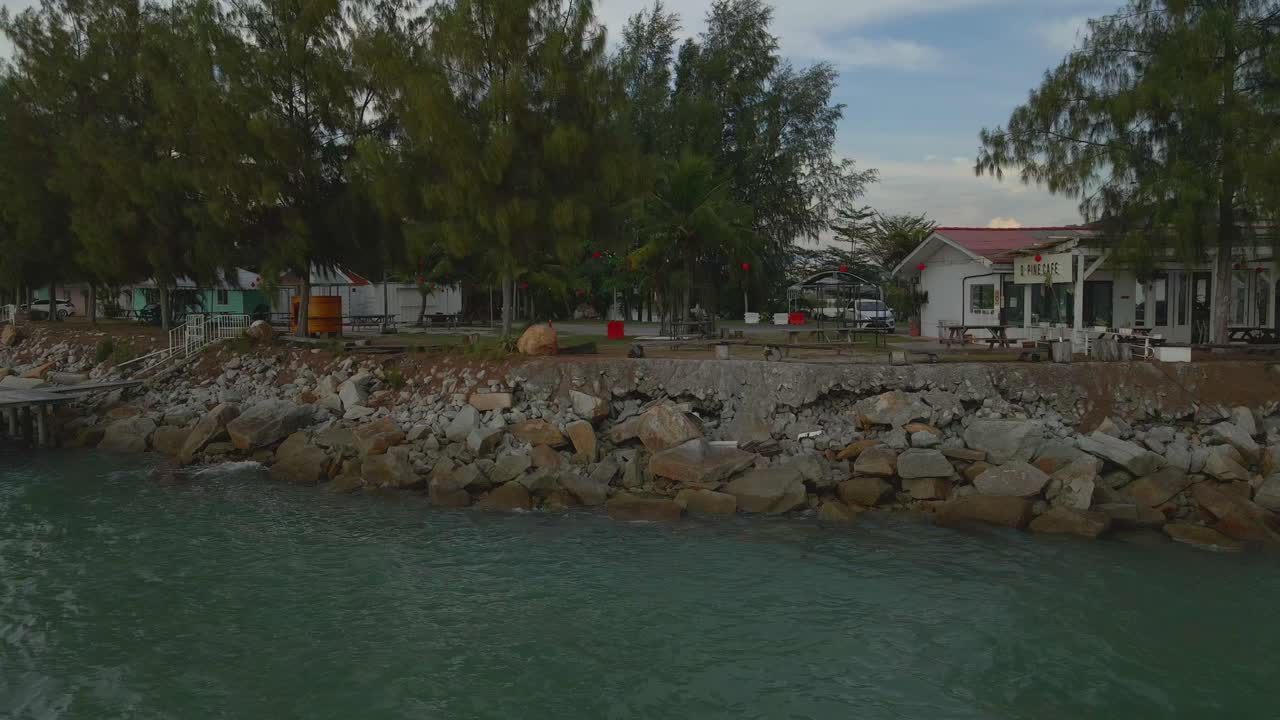 Drone view of a row of seafront villas in the evening, Marina Island, Malaysia