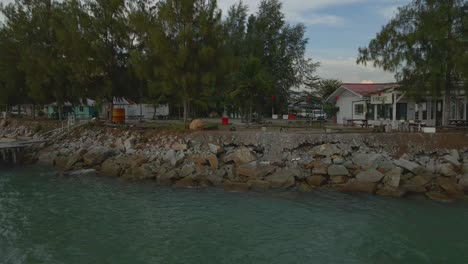 drone view of a row of seafront villas in the evening, marina island, malaysia