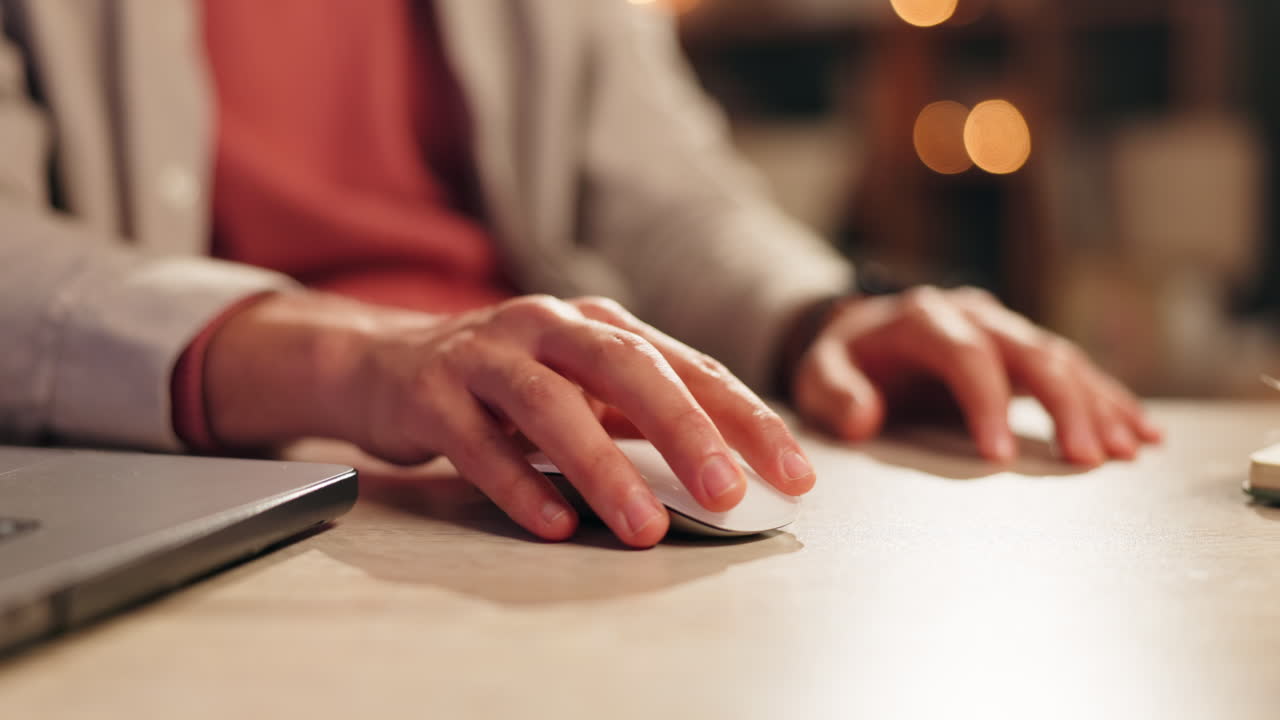 Close-up of hand using computer mouse
