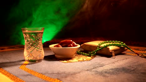 water and dates. iftar is the evening meal. slider view of decoration ramadan kareem holiday. festive greeting card, invitation for muslim holy month ramadan kareem. dark background. selective focus