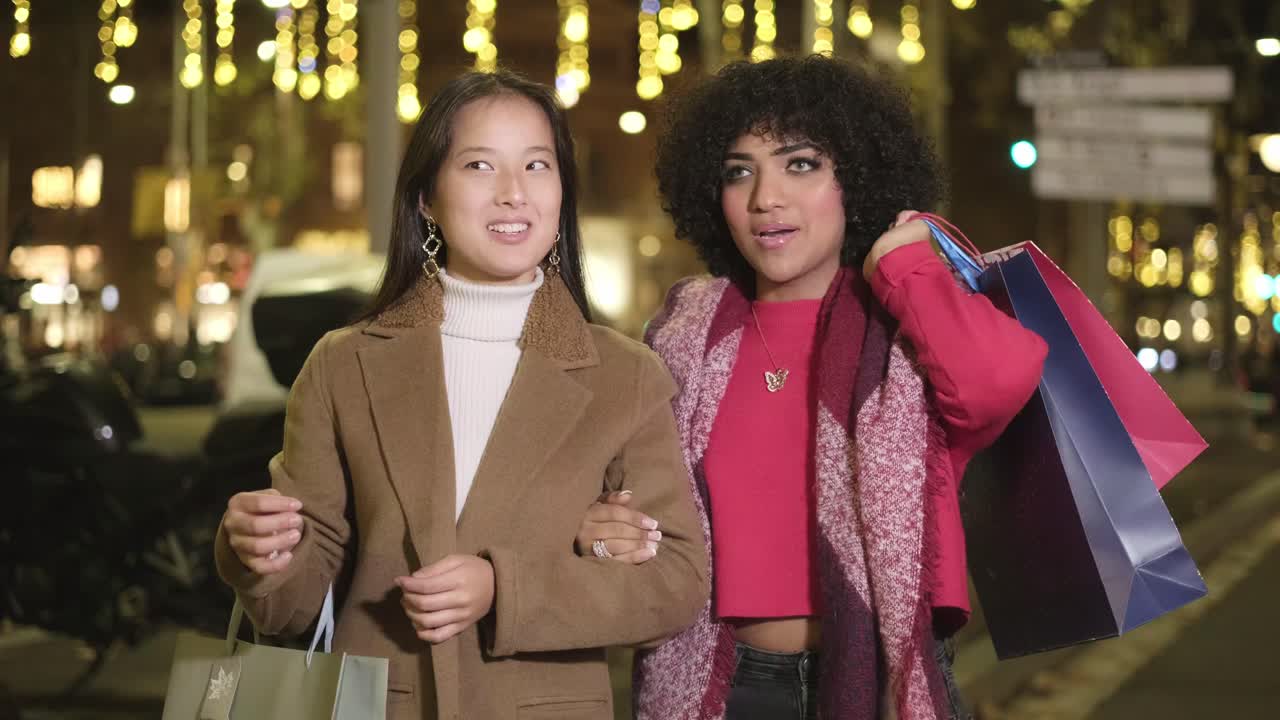 Two women shopping at night