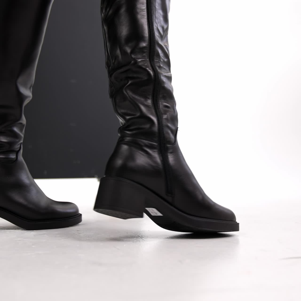 Boutique lady shoes trying. Woman stylish footwear showroom