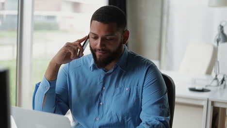 Cheerful-young-brunet-talking-on-smartphone.