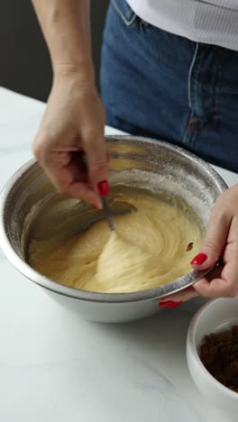 woman mixing dough in a bowl