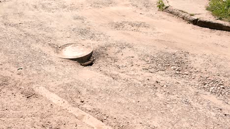 sewer cover on the road in the city.