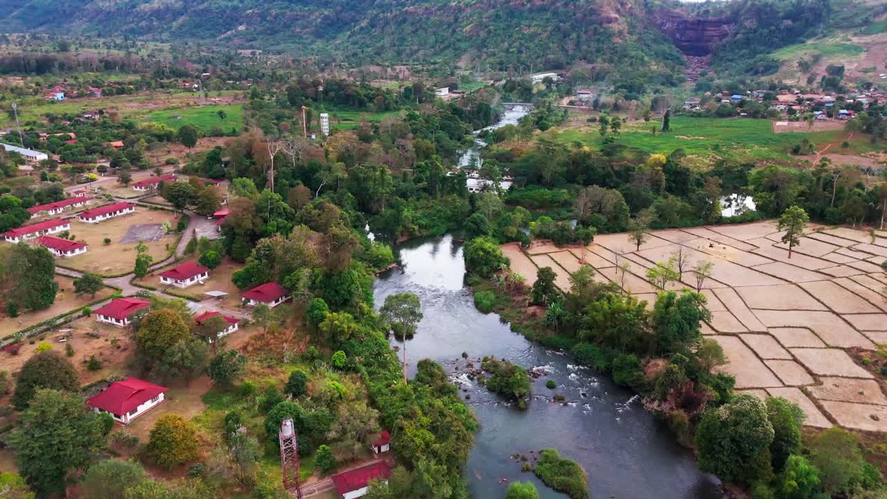 Aerial drone fly at Bolaven Plateau, Lush green mountain village in South Laos along River landscape