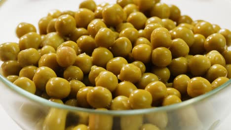 canned green peas in a glass bowl