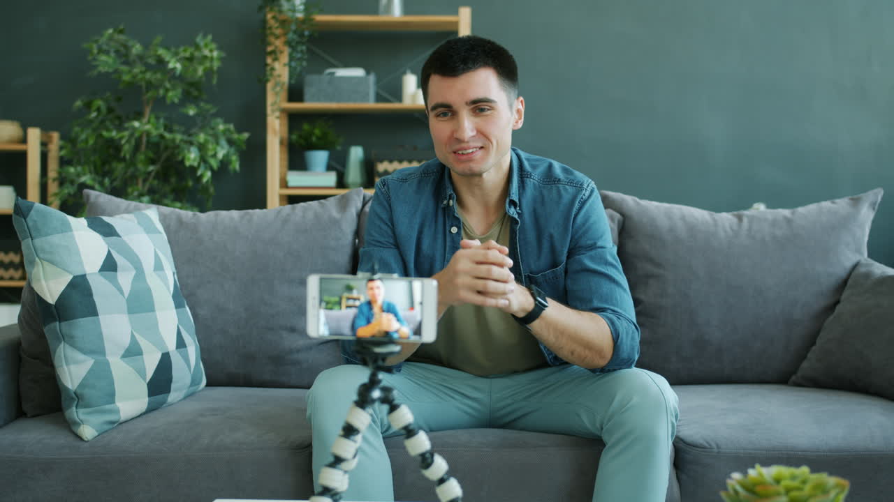 Man conducting a video call from his living room