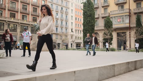 stylish young woman walking on the old big city and going down the steps