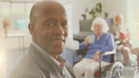 Animation-of-glowing-light-over-portrait-of-happy-senior-man