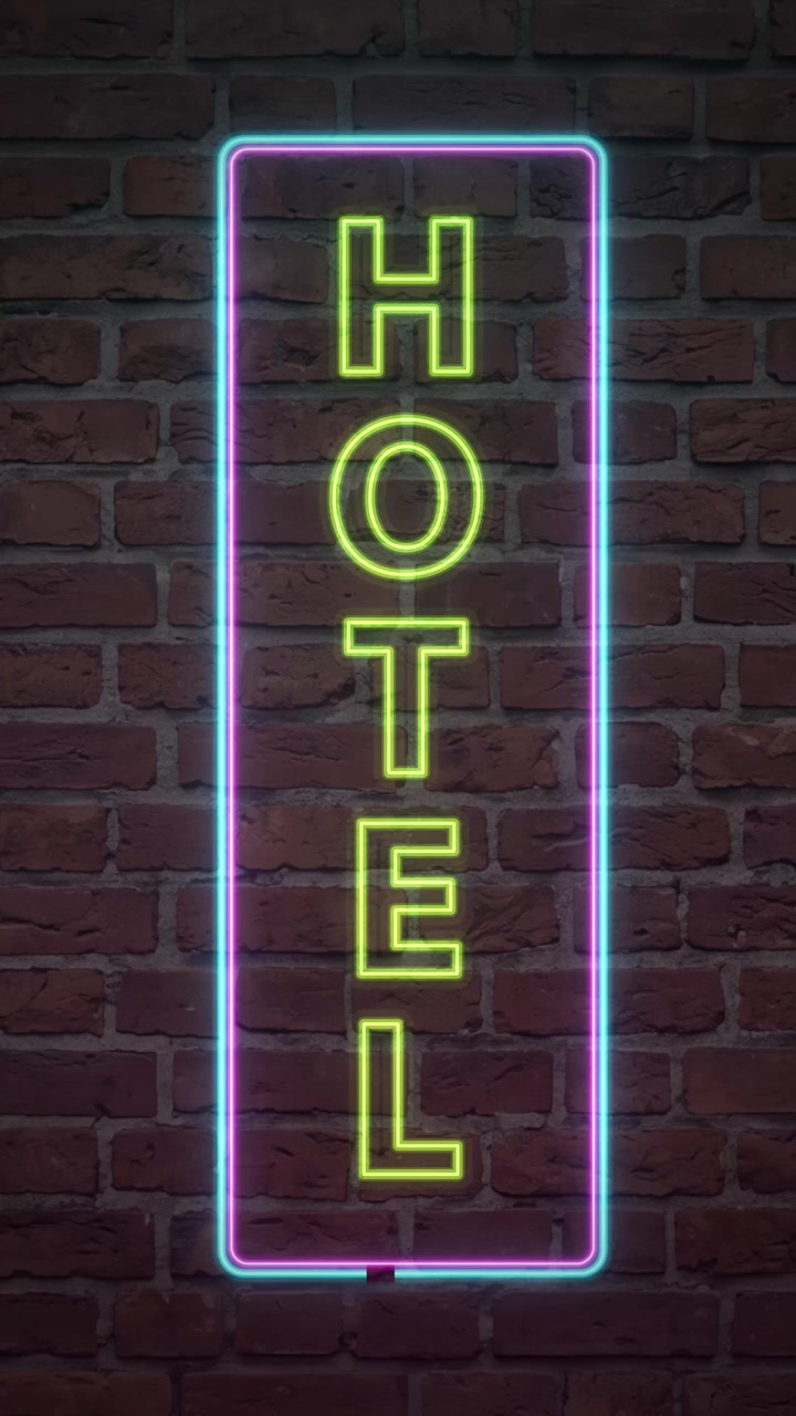 Enseigne d'hôtel néon verte et bleue lumineuse qui pulse et vacille sur un mur de briques sombres