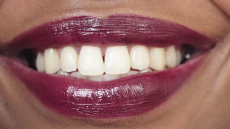 close up african american woman lips smiling happy healthy teeth glossy lipstick makeup cosmetics