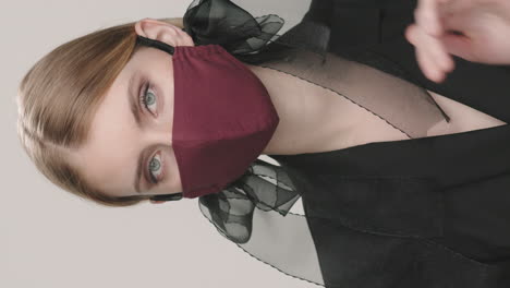 vertical portrait of woman in stylish face mask