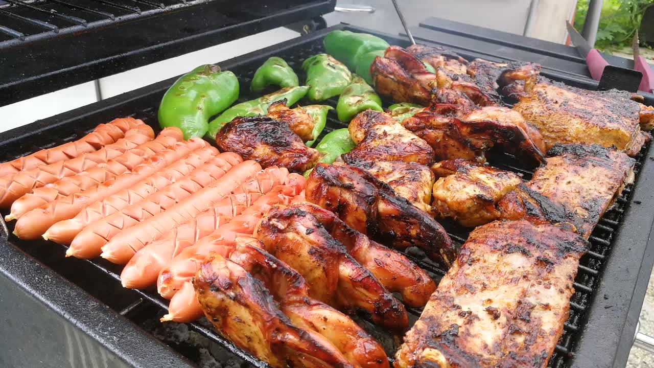Baking some meat on the barbecue. Some detailed footage of meat and vegetables.