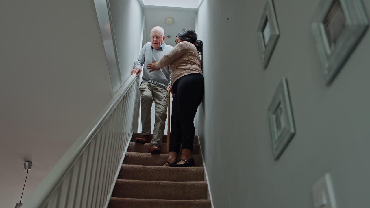 Caregiver assisting elderly man on stairs