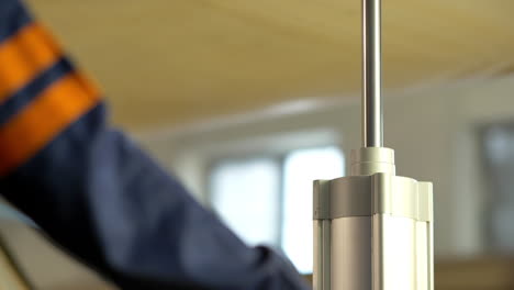 closeup shot of factory worker operating industrial machinery in a woodworking shop