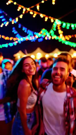people dancing and celebrating at a vibrant night party with colorful lights