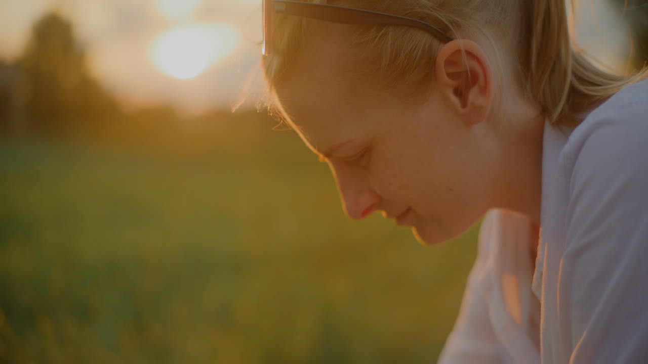 Close-Up of Woman Looking Into Baby Stroller at Sunset