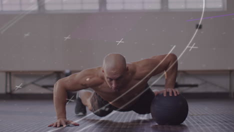 animation of circles and crosses over fit caucasian man exercising with ball at gym