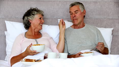 Mature-couple-enjoying-their-breakfast-together