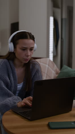 couple enjoying a video call and listening to music together at home