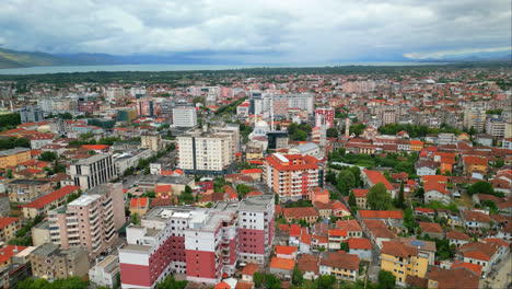 dron aéreo que se mueve hacia adelante disparado sobre edificios y casas de la ciudad en shkodra, también conocido como shkoder o scutari en el noroeste de albania en un día nublado