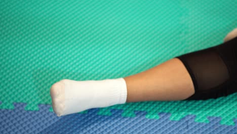 arm in sock on green rubber mat, depicting a relaxed and comfortable mood