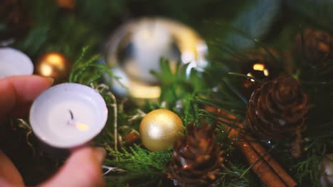 A-burnt-candle-is-removed-from-the-Advent-wreath,-the-background-is-slightly-blurred