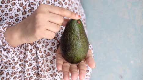 person holding an avocado