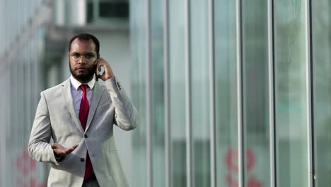 front view of african american businessman talking on smartphone