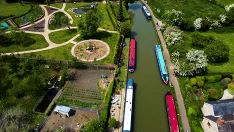 bustling grand union canal in stoke bruerne, aerial dolly bird's eye view