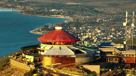 Aerial-View-Of-Cerro-Otto-Peak-Cable-Car-Resort-With-Golden-Sunshine