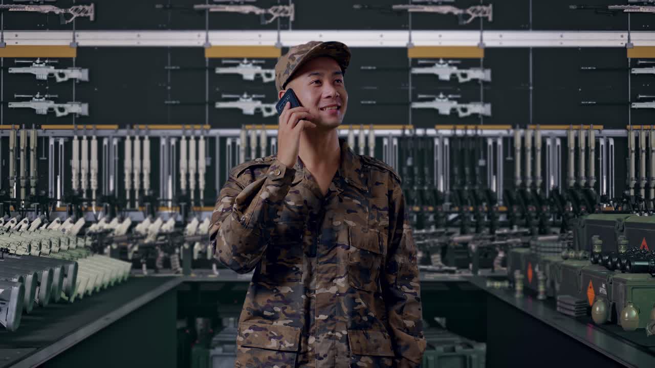 Asian man soldier talking on smartphone and looking around In Military Armory