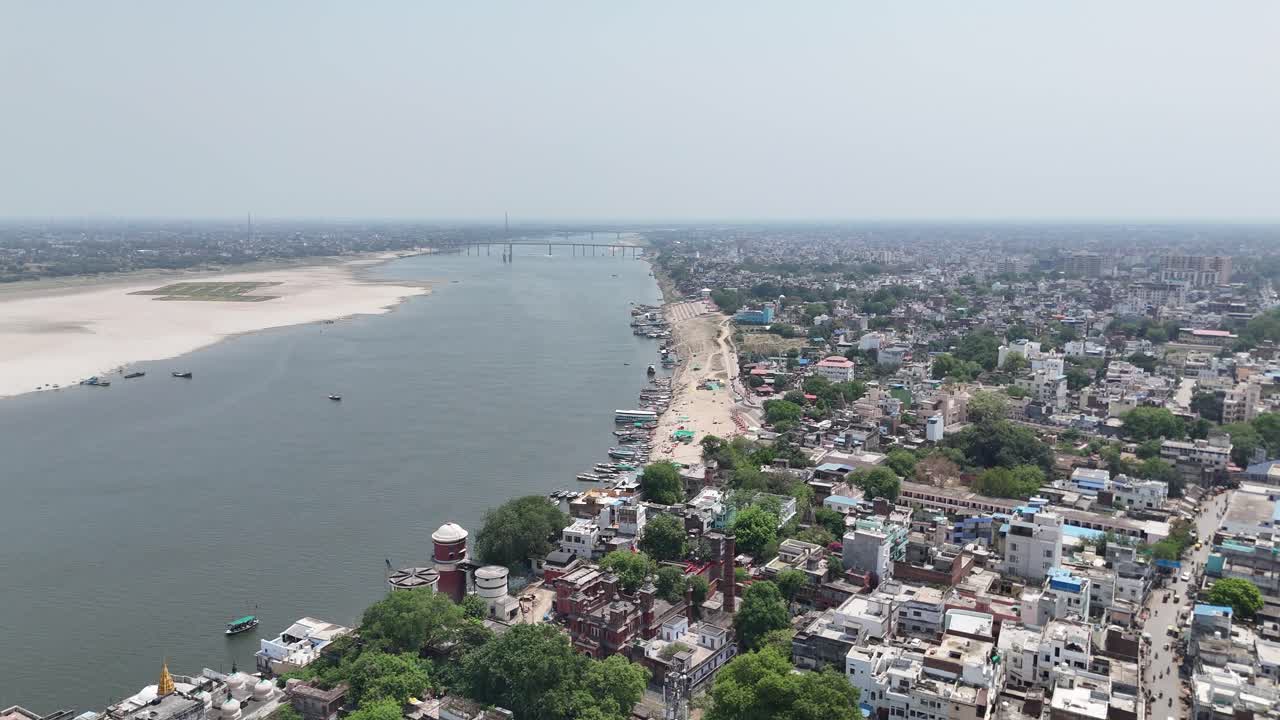 High-angle view capturing the crowded, chaotic energy of Varanasi's riverfront, where ancient rituals and modern life blend seamlessly.