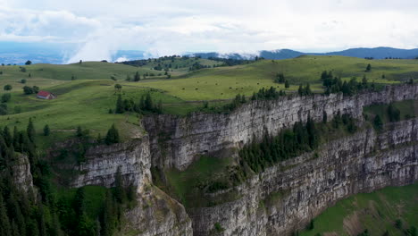rotating drone shot of creux du van in switzerland, located at the border of the cantons of neuenburg and vaud