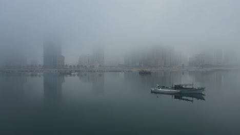 drone view of fog in the uae, sharjah's al khan beach covered in the winter morning fog, united arab emirates, 4k drone footage