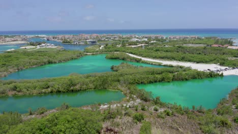 backward flight showing cap cana marina from blue lake, sunny afternoon, green water, nice weather