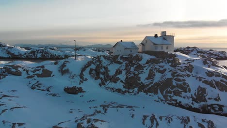 drone view of a house in a snowy landscape