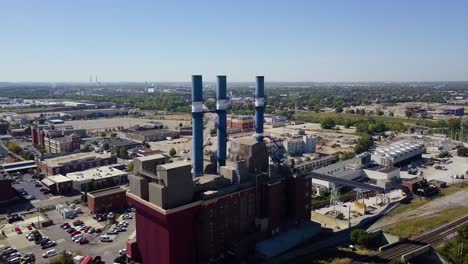 Aerial-establishing-shot-of-a-brewery-with-large-smokestacks-in-Indianapolis