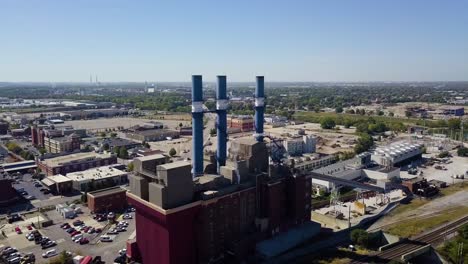 aerial establishing shot of a brewery with large smokestacks in indianapolis