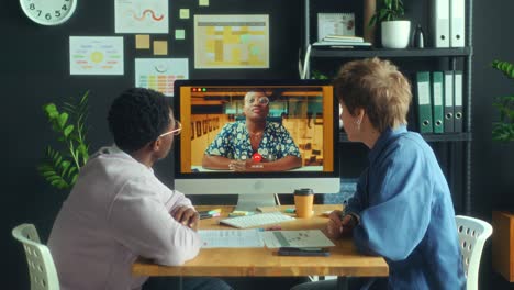 colleagues having e-meeting on video call with female manager