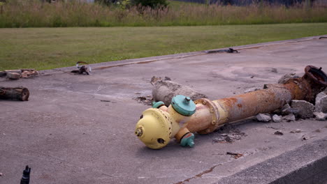 abandoned fire hydrant lays in ruin