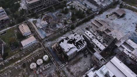 abandoned oil refinery factory destroyed in war or earthquake, aerial top down view